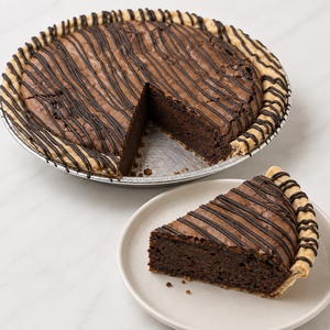 Sliced Mississippi Mud pie showing the filling, crust and a generous slice ready to serve